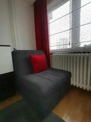 a black couch with a red pillow in a room at Srce grada Gradiška in Bosanska Gradiška