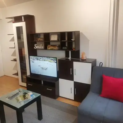 a living room with a tv and a couch and a table at Srce grada Gradiška in Bosanska Gradiška