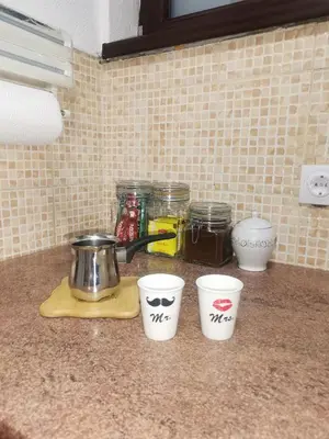 four cups on a kitchen counter with spices at Srce grada Gradiška in Bosanska Gradiška