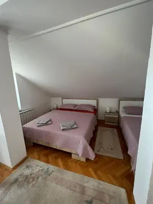 a bedroom with two beds in a attic at White house in Bihać