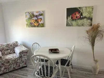 a living room with a table and a chair at White house in Bihać