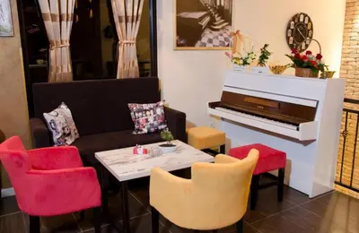 a living room with a couch and a table and a piano at Apartments Padrino BP in Bosanski Novi