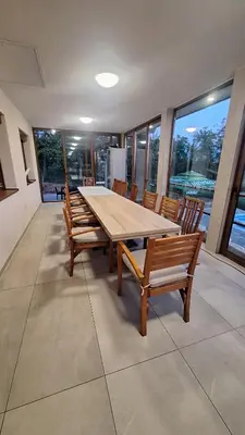 a dining room with a wooden table and chairs at Vikendica El Paradiso Banjaluka in Laktaši