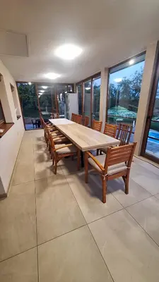 a large dining room with a wooden table and chairs at Vikendica El Paradiso Banjaluka in Laktaši