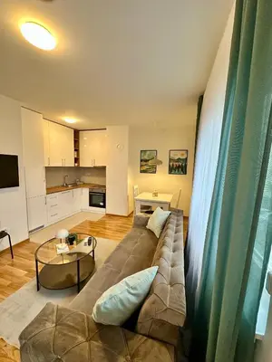 a living room with a couch and a table at Apartman Mint&White Borik in Banja Luka