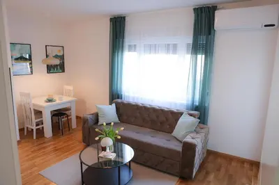 a living room with a couch and a table at Apartman Mint&White Borik in Banja Luka