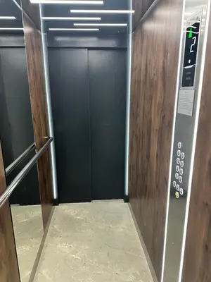 an elevator with a door with a sign on it at Apartman Mint&White Borik in Banja Luka