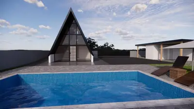 a house with a swimming pool and a church at Vikendica sa bazenom HUZUR in Cazin