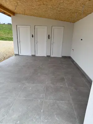 a room with three doors and a tile floor at Vikendica sa bazenom HUZUR in Cazin