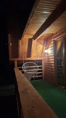 a porch with a swing in a cabin at Vikendica Elenda Banja Luka in Laktaši