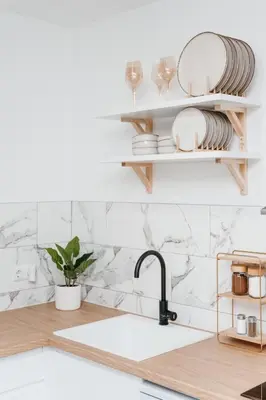 a kitchen with white marble walls and a sink at Apartment Friday in Travnik