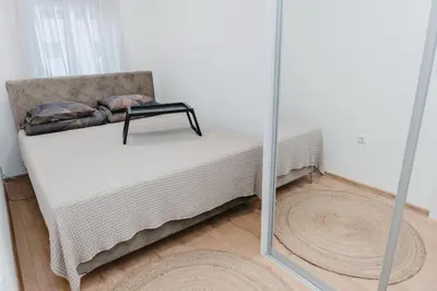 a room with a bed and a mirror at Apartment Friday in Travnik