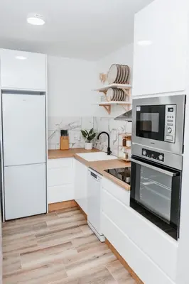 a white kitchen with a refrigerator and a microwave at Apartment Friday in Travnik