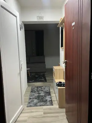 an open door to a living room with a couch at Apartman Ivana in Banja Luka