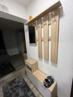 a room with wooden cabinets on a wall at Apartman Ivana in Banja Luka