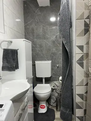 a bathroom with a white toilet and a sink at Apartman Ivana in Banja Luka