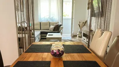 a living room with a table and a living room with a couch at Apartment in Doboj - City Center - Cik Cak in Doboj