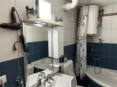 a bathroom with a sink and a toilet and a mirror at Apartment in Doboj - City Center - Cik Cak in Doboj