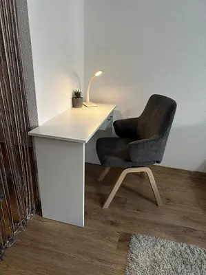 a white desk with a chair and a lamp at Apartment in Doboj - City Center - Cik Cak in Doboj