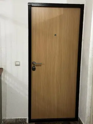 a wooden door with a metal handle in a room at Apartment in Doboj - City Center - Cik Cak in Doboj