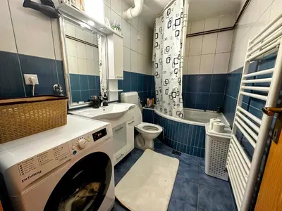 a blue and white bathroom with a washing machine at Apartment in Doboj - City Center - Cik Cak in Doboj