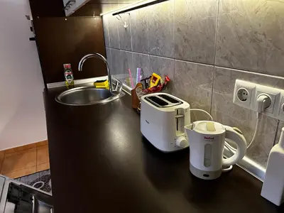 a kitchen counter with a sink and two coffee makers on it at Apartment in Doboj - City Center - Cik Cak in Doboj