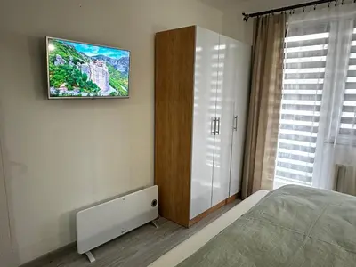 a bedroom with a bed and a tv on the wall at Apartment in Doboj - City Center - Cik Cak in Doboj