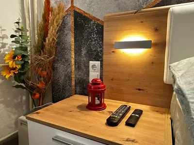 a table with two remote controls on top of a bed at Apartment in Doboj - City Center - Cik Cak in Doboj