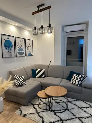 a living room with a couch and a table at City Apartment in Banja Luka