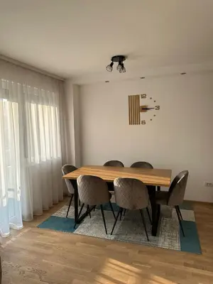 a dining room with a wooden table and chairs at City Apartment in Banja Luka