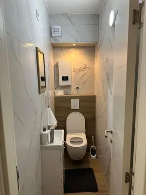 a small bathroom with a toilet and a sink at City Apartment in Banja Luka
