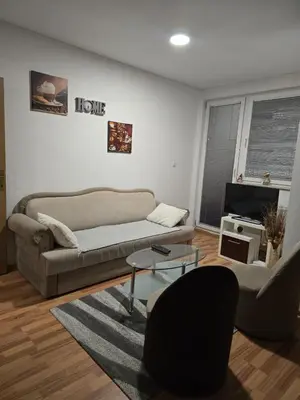 a living room with a couch and a table at Apartman Manjić in Doboj