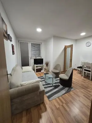 a living room with a couch and a table at Apartman Manjić in Doboj