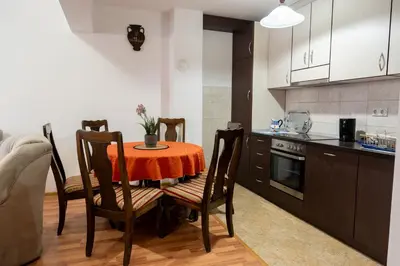 a kitchen with a table and chairs in a room at Gradina Stan na Dan in Doboj