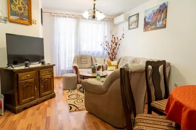 a living room with a couch and a tv at Gradina Stan na Dan in Doboj
