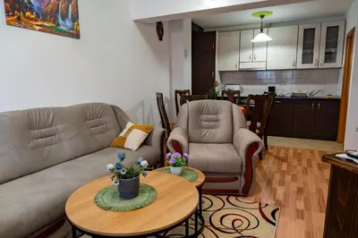 a living room with a couch and a table at Gradina Stan na Dan in Doboj