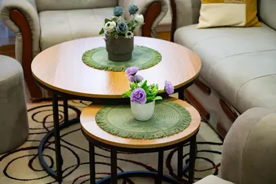 two tables with flowers on them in a living room at Gradina Stan na Dan in Doboj