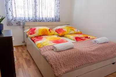 a bed with pillows on it in a bedroom at Gradina Stan na Dan in Doboj