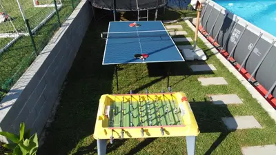 an overhead view of a ping pong table next to a pool at Vikendica VILLA A1 in Banja Luka