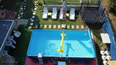 an overhead view of a swimming pool with a toy clock at Vikendica VILLA A1 in Banja Luka