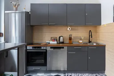 a kitchen with gray cabinets and a sink at Apartman Bn Vlasic in Vlasic