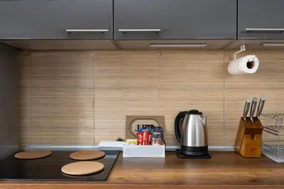 a kitchen with a counter with stools and a coffee maker at Apartman Bn Vlasic in Vlasic
