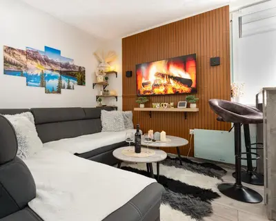 a living room with a couch and a table at Apartman Bn Vlasic in Vlasic