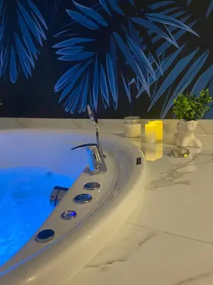 a white sink with a faucet in a bathroom at Kalipso spa apartman sa jakuzzijem in Doboj
