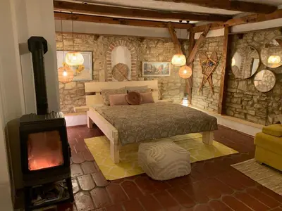 a bedroom with a bed and a wood stove at Sokograd Royal in Šipovo