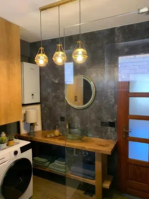 a kitchen with a table and some lights at Sokograd Royal in Šipovo