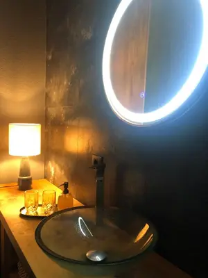 a bathroom with a sink with a light on it at Sokograd Royal in Šipovo