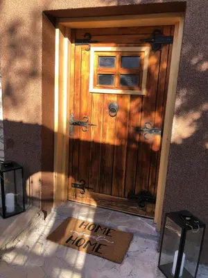 a wooden door with a home home home sign on it at Sokograd Royal in Šipovo