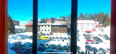 a view from a window of a parking lot with snow at Apartman Dila in Vlasic
