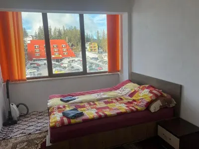a bedroom with a bed in front of a window at Apartman Dila in Vlasic